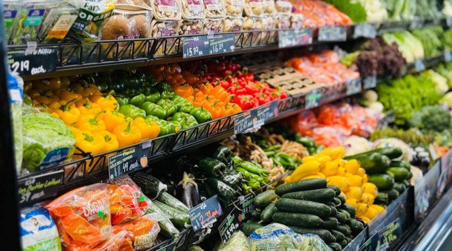 Fresh vegetables neatly arranged on grocery store produce shelves